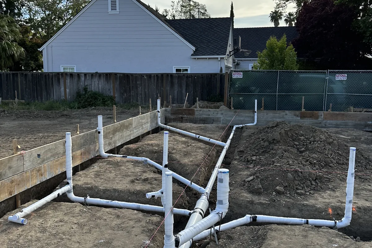 Sewer and drain lines laid out and graded for reliable flow at a Central Coast property.