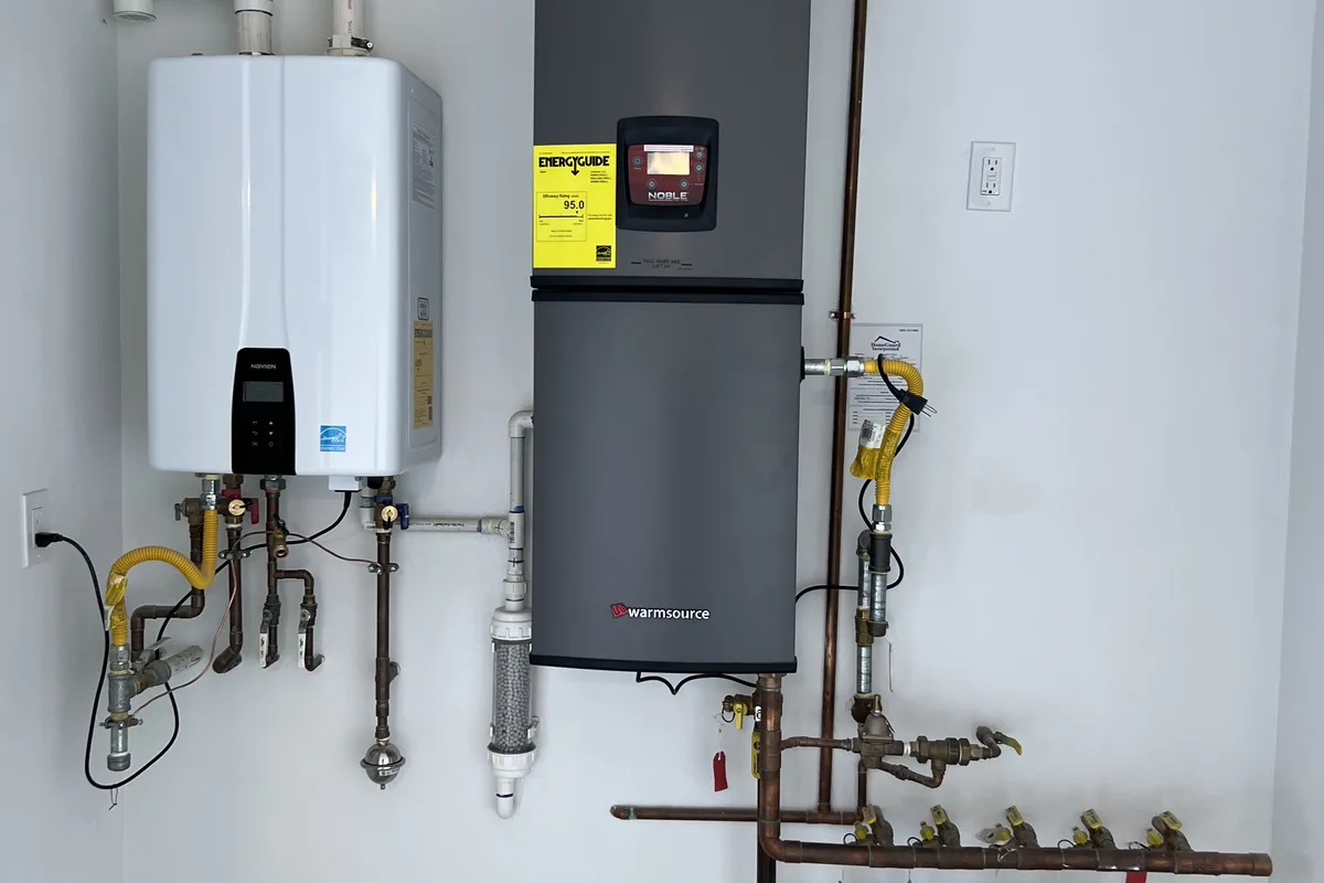 Water conditioning equipment installed alongside a tankless water heater to protect it from hard water scale.