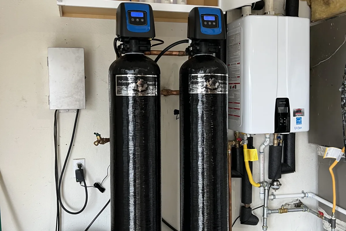 Whole-house water softener and filtration setup plumbed with a service bypass loop in a Hollister home.